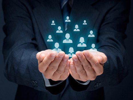 Businessman holding holographic icons of people symbolizing PPC management services capturing leads.