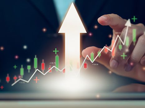 Hand pointing to arrow and rising graph indicating SEO services can enhance marketing performance.